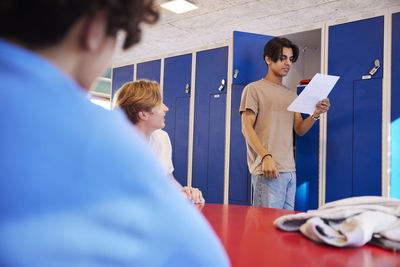 Teenage boys talking in locker room