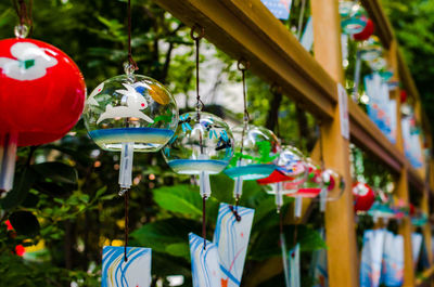 Close-up of multi colored decorations hanging on table at market