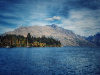 Scenic view of mountains against blue sky