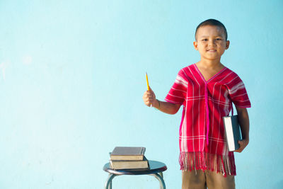 Boy against blue background