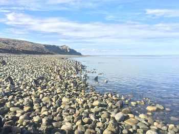 Scenic view of calm sea against cloudy sky