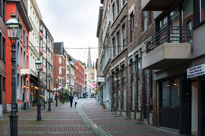 Street amidst buildings in city against sky