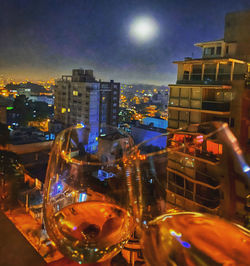 Digital composite image of illuminated street and buildings at night