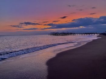 Scenic view of beach against sky during sunset