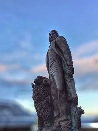 Low angle view of statue against sky