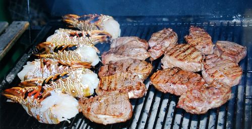 High angle view of meat on barbecue grill