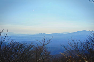 Scenic view of mountains against blue sky