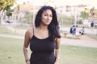 Portrait of beautiful young woman standing outdoors