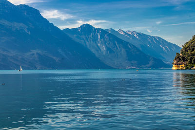 Scenic view of sea and mountains against sky