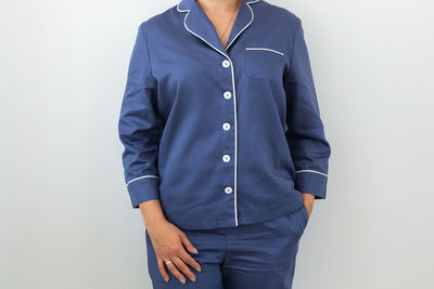 Midsection of man standing against white background