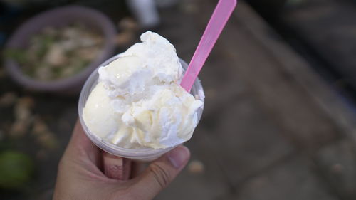 Close-up of hand holding ice cream