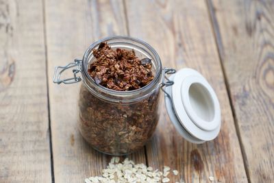 Close-up of oat flakes in jar on table