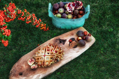 High angle view of fruits in basket on field