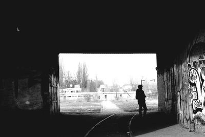 Full length of woman walking on tiled floor