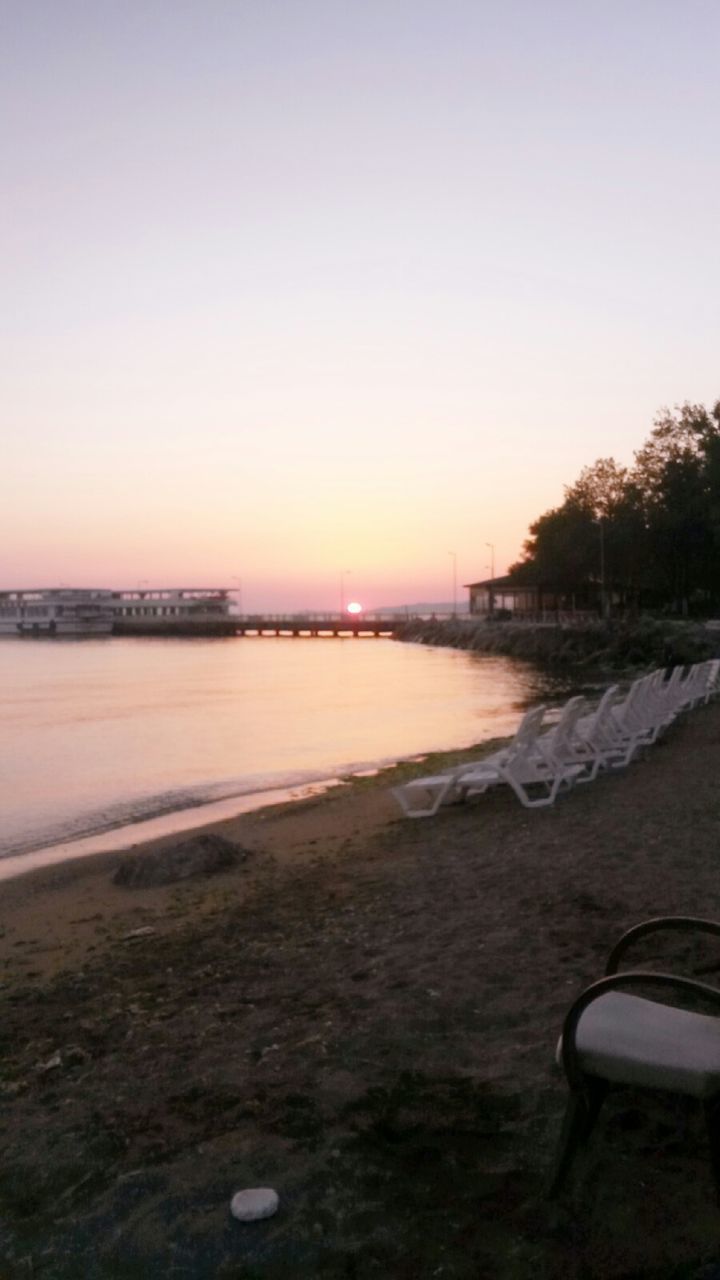 water, beach, shore, sea, tranquil scene, clear sky, scenics, tranquility, sunset, beauty in nature, sand, nature, copy space, sky, idyllic, coastline, horizon over water, wave, outdoors, no people