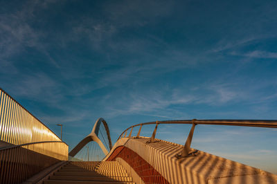 Low angle view of bridge against cloudy sky