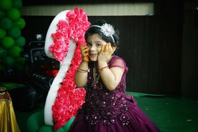 Portrait of happy girl with pink mask