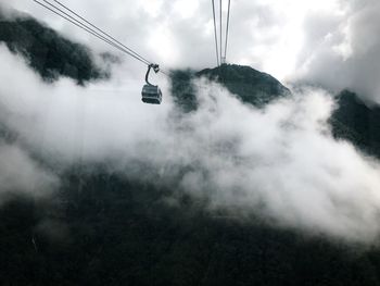 Overhead cable car against sky