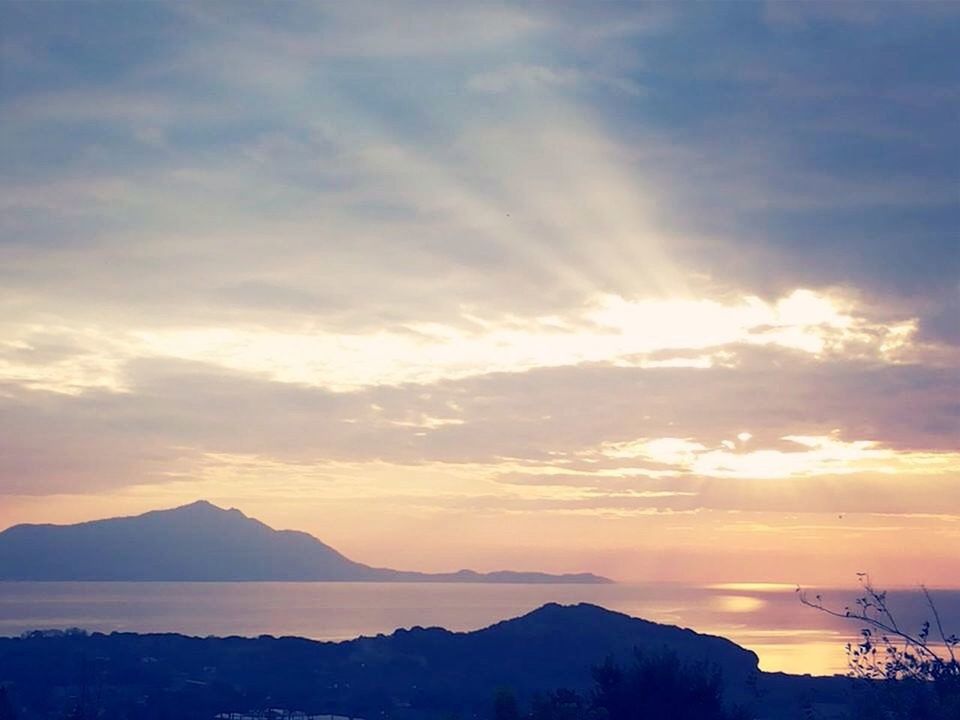 sunset, scenics, tranquil scene, sky, tranquility, beauty in nature, cloud - sky, water, nature, idyllic, cloud, silhouette, orange color, reflection, waterfront, sea, mountain, sun, moody sky, cloudy