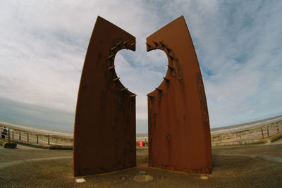 Heart shape on wall against sky