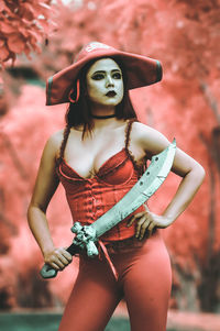 Young woman wearing red costume while standing outdoors