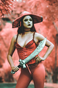 Portrait of young woman wearing hat standing outdoors