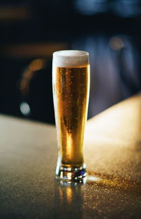 Close-up of beer glass on table