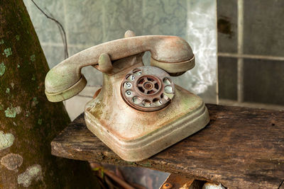 Close-up of old telephone on table