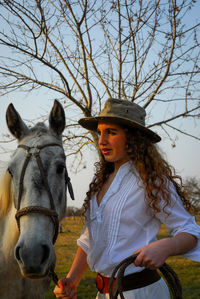 Photo session of a young girl dressed as a gaucho and her riding horse