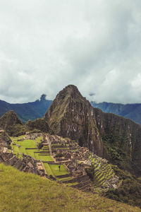 Scenic view of mountain against cloudy sky