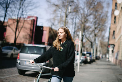 Young woman smiling on street in city