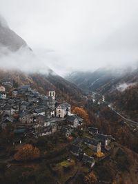 High angle view of town on mountain during foggy weather
