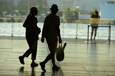 Man and woman walking together with polythene bags
