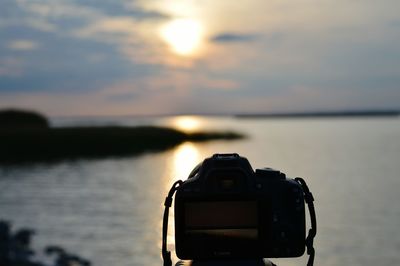 View of camera against cloudy sky