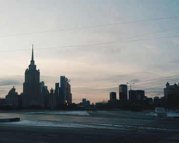 View of cityscape against cloudy sky