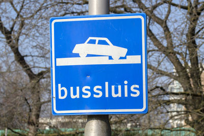 Low angle view of road sign against trees