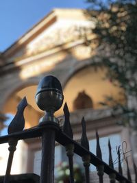 Close-up of metal railing against building