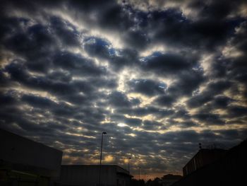 Low angle view of cloudy sky over town