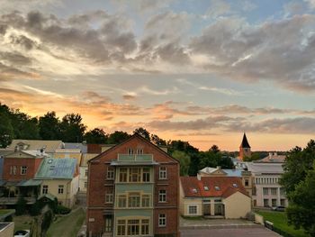 Houses against sky during sunset