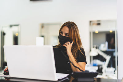 Woman using laptop on table