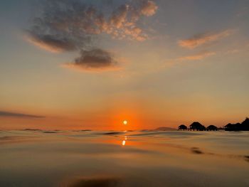 Scenic view of sea against romantic sky at sunset