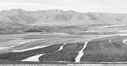 Scenic view of arid landscape against sky