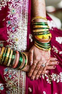 Midsection of woman with tattoo on hand