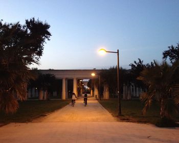 Illuminated street light against sky