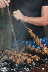 Midsection of man preparing food