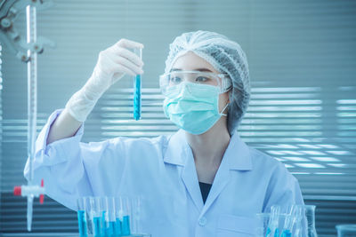 Close-up of female scientist experimenting in laboratory