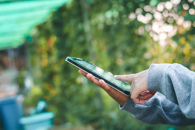 Midsection of person using mobile phone