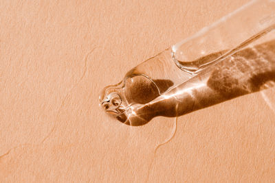 Close-up of water bottle against yellow wall