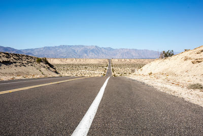 Empty road against sky