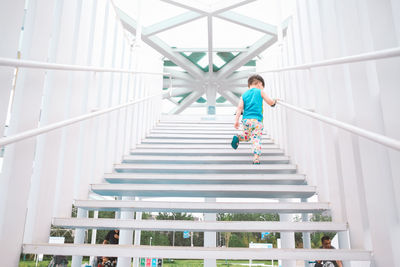 Full length of woman walking on staircase